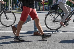 A group of people walking and biking