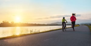 Woman and son, running and cycling together.