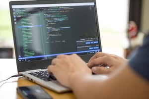 Man coding on his laptop